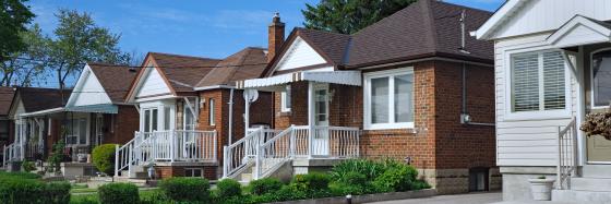 street view of one story brick and vinyl sided homes.